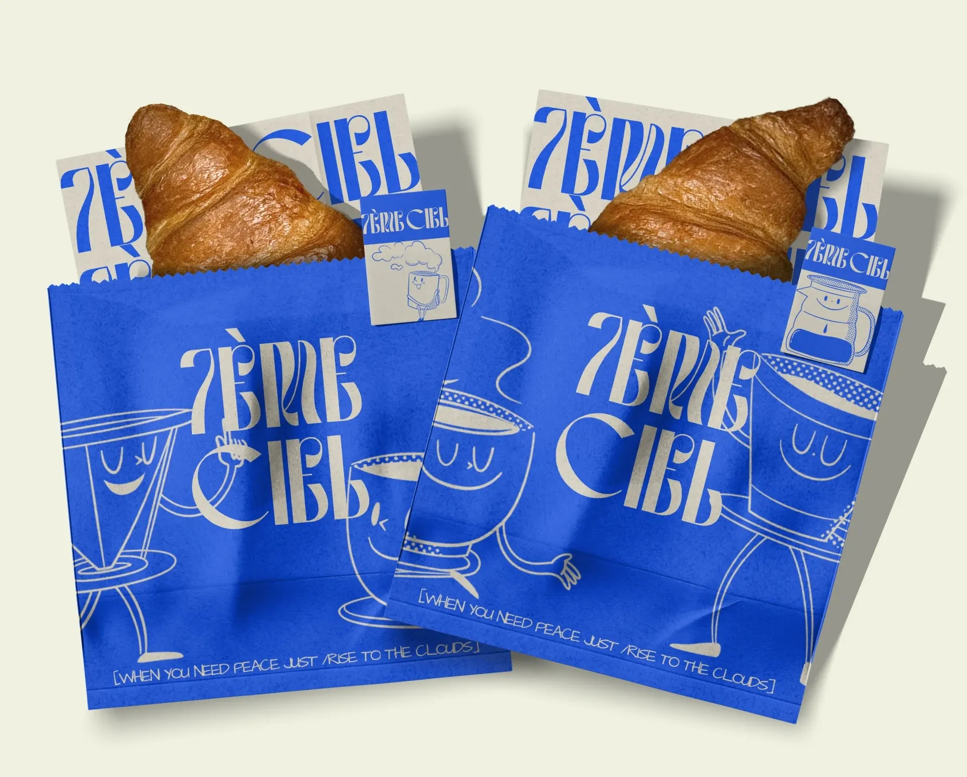 Packaging 7ème Ciel : sachets bleus illustrés et cartes de visite avec viennoiseries
